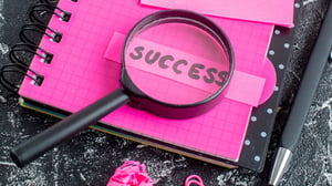 2-view-pink-notepad-with-pen-magnifier-success-note-gray-background